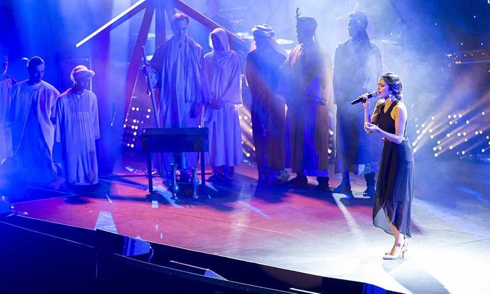 Event photography by Dale Travers Photography in Brisbane. Image shows woman on stage singing with Christmas scene in background.