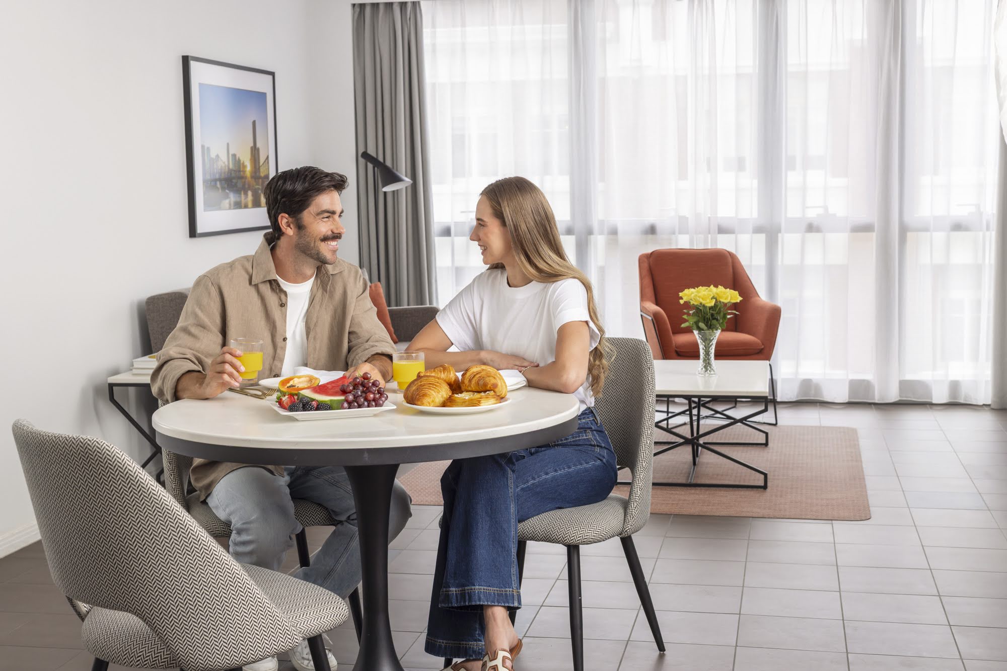 Corporate photo shoot for Meriton. image shows couple seated at breakfast table in hotel room.